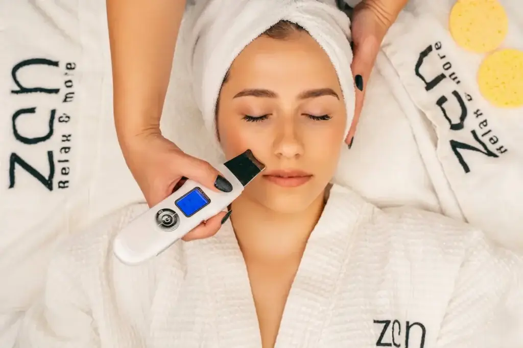Ultrasonic facial treatment being performed to deeply cleanse, exfoliate, and improve skin texture in a spa setting